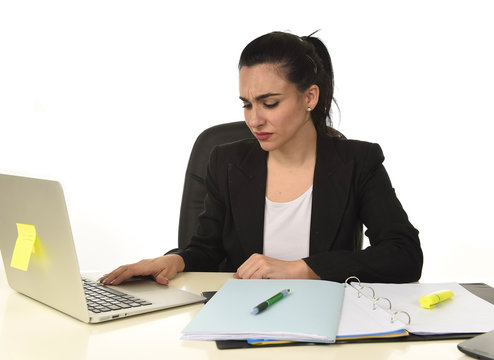 attractive woman in business suit working tired and bored in office computer desk looking sad