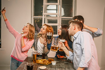 Group of friends enjoying evening drinks with beer
