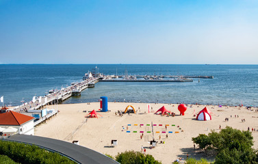 Sopot, Poland. Wooden pier (molo), beach and Baltic Sea - obrazy, fototapety, plakaty