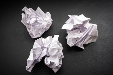 Crumpled paper on a black background. Selective focus.