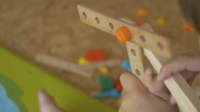 child is playing in the game room of wood products fasteners bolts spanner