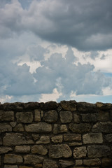 Old stone wall against dark clouds at Kalemegdan fortress in Belgrade, Serbia