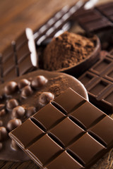 Chocolate bar, candy sweet, dessert food on wooden background