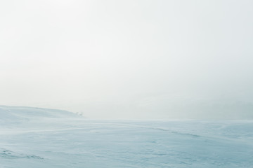 A beautiful, minimalist landscape of flat, snowy Norwegian field. Clean, light, high key, decorative look.