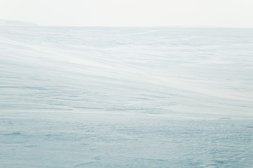 A beautiful, minimalist landscape of flat, snowy Norwegian field. Clean, light, high key,...