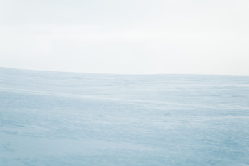 A beautiful, minimalist landscape of flat, snowy Norwegian field. Clean, light, high key,...