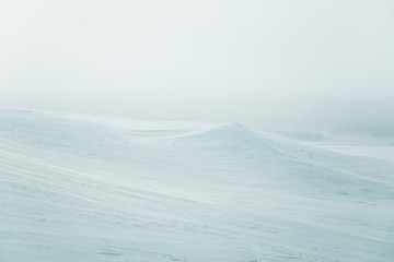 A beautiful, minimalist landscape of snowy Norwegian hills. Clean, light, high key, decorative look.