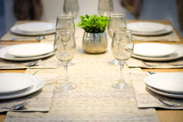 Plates and wine glasses on the table were empty.