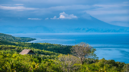 Beautifull evening view to St. Agung Vulcano on Bali from Nusa Penida Island. Partly Covered by Clouds. Indonesia