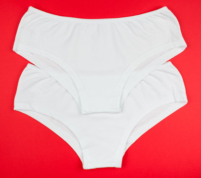 Women's cotton panties flowered isolated on red background.