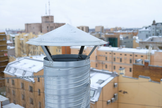 exhaust pipe on the background of the roofs of the city