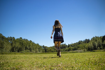 Girl walking on greenfield 