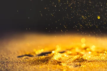 Foto op Plexiglas Licht en schaduw Sprinkle gold dust on a black background with copy space