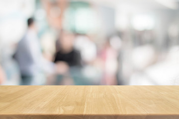 Wood table top and blurred bokeh business work space interior background - can used for display or montage your products.
