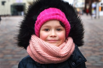 Portrait of happy little girl at a port