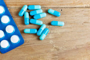 Capsules drug blue on wood table