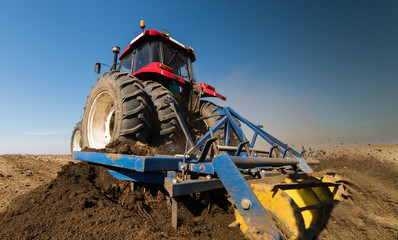 Tractor preparing land