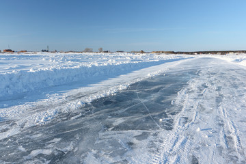 Ice road on a frozen reservoir in the winter,  Ob River, Siberia, Russia