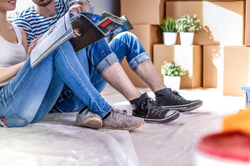 Couple moving in house sitting on the floor