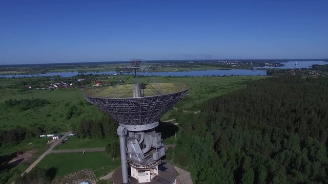 A huge radio telescope in the forest. The steerable parabolic reflector 64 meters diameter. Observatory for spectral radio astronomy, physics of pulsars and pulsar astrometry, studies of galactic and 