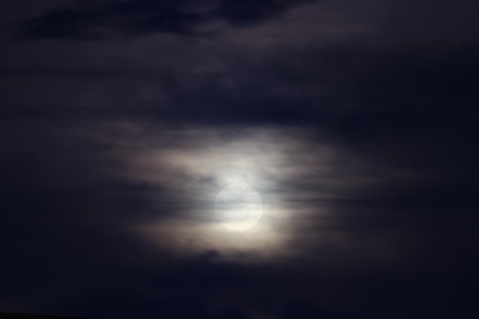 Full moon beautiful over dark black sky at have raincloud in night