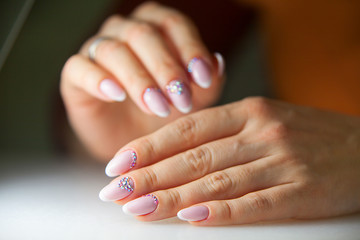 female pink French manicure on beautiful background