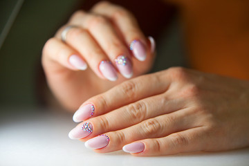 Obraz na płótnie Canvas female pink French manicure on beautiful background