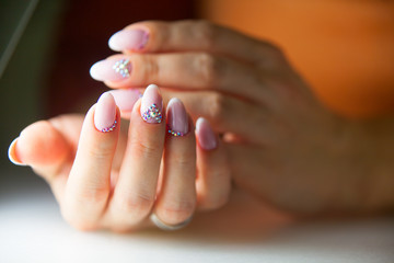 female pink French manicure on beautiful background