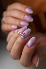 female pink French manicure on beautiful background