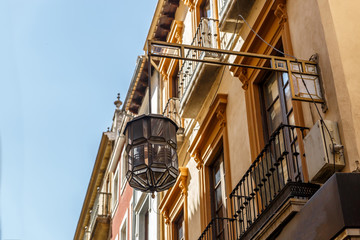 View of a large street lamp hanging from a facade