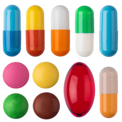 Many colorful pills and tablets isolated on white