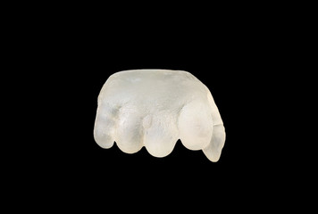 Baby hand forming by resin isolated on black background. New life concept.