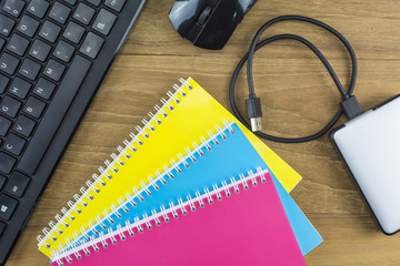 The school supplies placed on the wooden floor