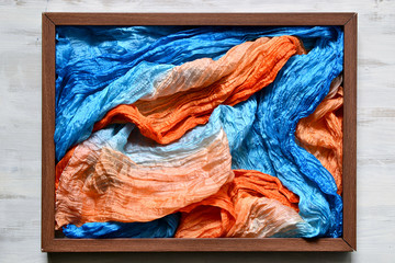 Wooden frame filled with multicolored silk headscarf