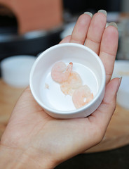 Hand holding cup of Shrimps, Homemade pizza
