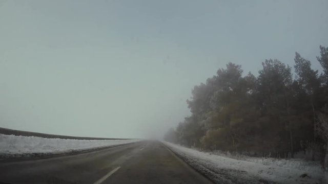 Driving car in winter in fog