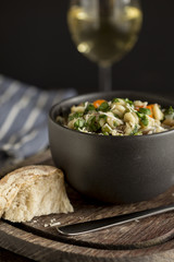 Minestrone soup with bread and white wine