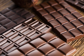 Chocolate bar, candy sweet, dessert food on wooden background
