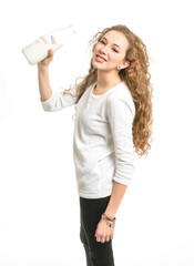 Attractive young girl with milk bottle on white background