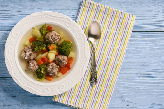 Clear soup with vegetables and beef meatballs.