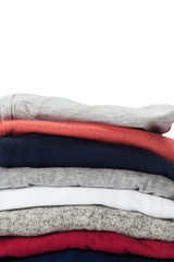 Stack of clothes on white background, closeup