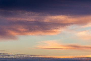 Fototapeta premium Beautiful cloudy sky background with sunset lights in violet tones