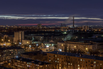 Fototapeta na wymiar Night aerial winter cityscape view of industrial and living area in Voronezh
