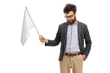 Man with his head down holding a white flag - obrazy, fototapety, plakaty