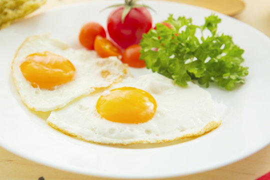 Fried eggs with tomatoes, traditional breakfast
