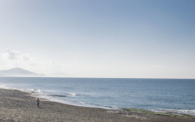 Fototapeta na wymiar Man walking on the beach. Seascape. Mediterranean Sea