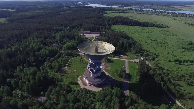 A huge radio telescope in the forest. The steerable parabolic reflector 64 meters diameter. Observatory for spectral radio astronomy, physics of pulsars and pulsar astrometry, studies of galactic and 
