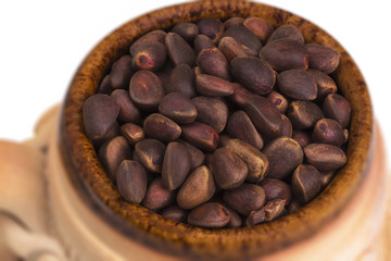 Decorative ceramic mug with pine nuts.