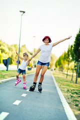 Obraz premium Mother and daughter rollerblading.