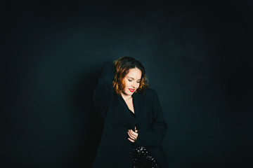 Studio portrait of  fashion glamor woman smiling with red lips on dark background